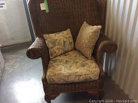 Front view of wicker armchair with cushions