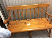 Front view of full pine hall bench showing spindle back and seat