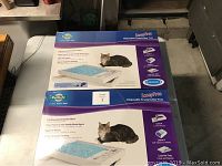 4 boxed Petsafe ScoopFree Disposable Crystal Litter Trays stacked showing front and top of the packaging.