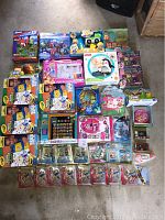 Wide overview of entire toy collection laid out on floor