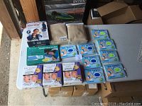 Wide view of lot items on white table showing all included health and comfort items as per seller description.