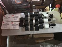 Overview of Sony alarm clock radios, power adapters, and various electronics on table