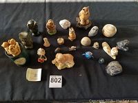 Full collection of owl and dog figurines displayed on black fabric background.
