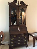 Full frontal view of entire two-piece secretary cabinet in room setting