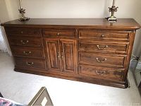 Front view of dresser cabinet showing all drawers and center doors