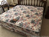 Front view of mattress and box spring set in bedroom