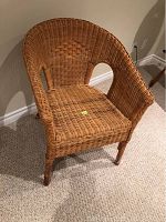 Front angled view of a single wicker chair showing woven seat, back with diamond pattern, and armrests.