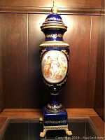 Full front view of cobalt blue urn with lid on display shelf
