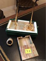 Full view of the onyx desk set items including double pen set, clock, and note paper tray with sliding cover, placed on a black desk.