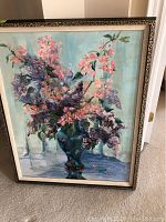 Front view of framed floral still life painting in decorative wooden frame