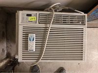Front view of Danby window air conditioner including remote and power cord