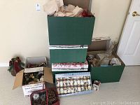 Overview of Christmas decoration lot including boxes, crackers, ribbons, and assorted decorations