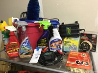 Full view of the car cleaning and detailing products including spray bottles, brushes, bucket, and accessories on a table.
