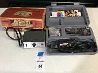 Dremel MultiPro rotary tool in gray plastic case with bits and accessories. Vintage solid state motor speed control box and its original package on table.