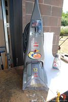Front view of the Bissell ProHeat upright carpet cleaner showing branding, model details, and power specifications.