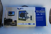 Front side of the Sanus F115 TV wall mount box showing product image and key features, including compatibility for 26-40 inch TVs, full-motion tilt and swivel, and easy assembly.