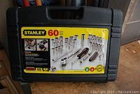 Closed Stanley 60-piece 3/8 inch socket set in hard plastic carrying case with yellow label.