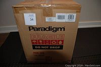 Sealed Paradigm PDR-100 in original cardboard box with Fragile and Do Not Drop labels.