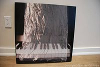 Front view of 'Watersong 2', showing abstract mixed media art with piano keyboard and scribble motifs.