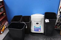 White Royal 10X cross-cut paper shredder with four large trash cans, one black and three dark brown, all rectangular plastic bins.
