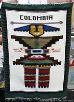 Full view front of the tapestry showing the design and text spelling 'COLOMBIA'.