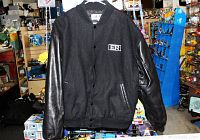 Front view of black ER TV Show jacket with leather sleeves and snap button front.