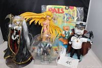 Various collectible figurines including anime and cartoon characters placed together on black backdrop