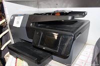 Front angle image of the black HP OfficeJet Pro 6835 printer showing the touchscreen control panel and document feeder.