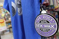 Close-up photo of circular Mr Zogs Original Sex Wax hang tag showing brand logo and tagline 'Never Spoils The Best For Your Stick'.