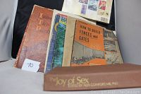 Books arranged showing titles including The Joy of Sex spine, How to Build Fences and Gates, ITP Post