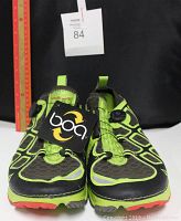 Front view of both Vasque tennis shoes showing the green and black mesh upper and visible Boa dial lacing system with tag attached.