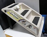 Angled view of beige plastic 3-step dog stairs with black traction pads.