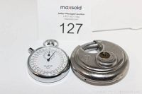 Photo of the vintage Alsta stopwatch and German stainless steel lock side by side on white surface, showing size and condition.