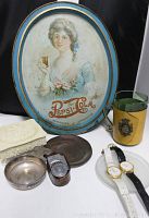 Full lot view showing collectible vintage Pepsi-Cola tray, green glass mug wrapped in leather and brass with coat of arms, two Guess quartz watches with leather straps, vintage Corona light meter wrapped in leather, vintage jewelry box with red felt and mirror inside, and various silvertone, bronze and glass change dishes.