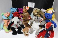 Photo showing a collection of 14 vintage Beanie Babies and teddy bears, each with a TY heart-shaped 'Beanie Baby' swing tag attached, set against a black background.