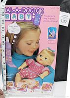 Front and side views of the boxed Hasbro Dial-A-Doctor Baby Doll showing box art and measured dimensions.