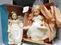 Two large Madame Alexander collectible porcelain dolls in original boxes with tissue paper. Both in cream vintage-style gowns with lace.