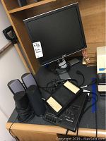 Dell 17" monitor with four Dell speakers and Panasonic transcriber with pedals on a desk, cables visible