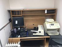 Full view of desk with shelf unit, showing scratches and overall condition. Includes other office items not part of the lot.