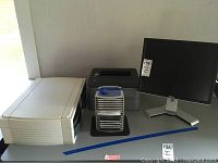 Dell monitor, Brother printer, white scanner, plastic CD storage case with software CDs shown together.
