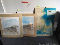 Two signed beach art prints by Perri Talas alongside Massachusetts coastal zone management map