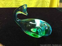 Photo of the vintage Chalet whale glass figurine showing the overall shape, color gradients, and curved tail detail.