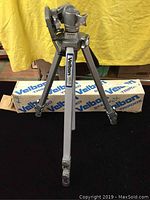 Full view of Velbon tripod standing with legs extended, box visible behind.