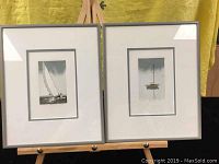 Pairs of framed limited-edition sailing prints displayed on an easel against a yellow backdrop.