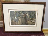 Framed print showing deer with antlers in natural setting, full view of framed artwork.
