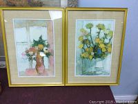 Pair of two framed floral prints signed Cathelin, showing both prints side by side.
