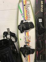 Top view of Hyperlite Fluid 137 wakeboard showing colored stripes and black bindings, displaying wear.