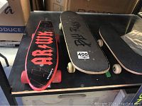 Overview of all three skateboards side by side on a black surface.