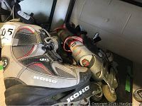 Pair of grey Koho Rollerblades showing overall wear including scratches and scuffs on boots and frames.