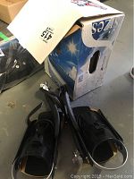 Pair of black Power Triangle snowboard bindings shown on floor beside original box with size 415 label.